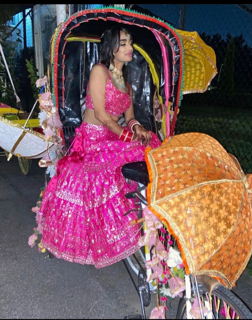 Our bride posing on a decorated rickshaw